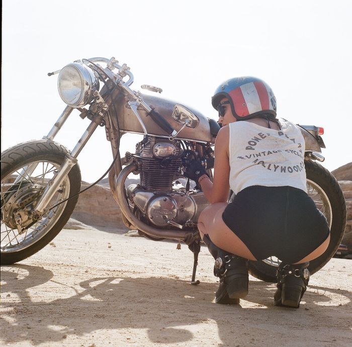 A playful frame from Girls on a motorcycle — online in Ahmedabad